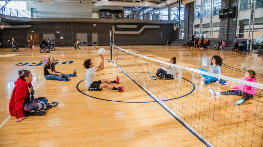 Students and visitors play sitting volleyball on Adaptive Recreation Day at UNCG