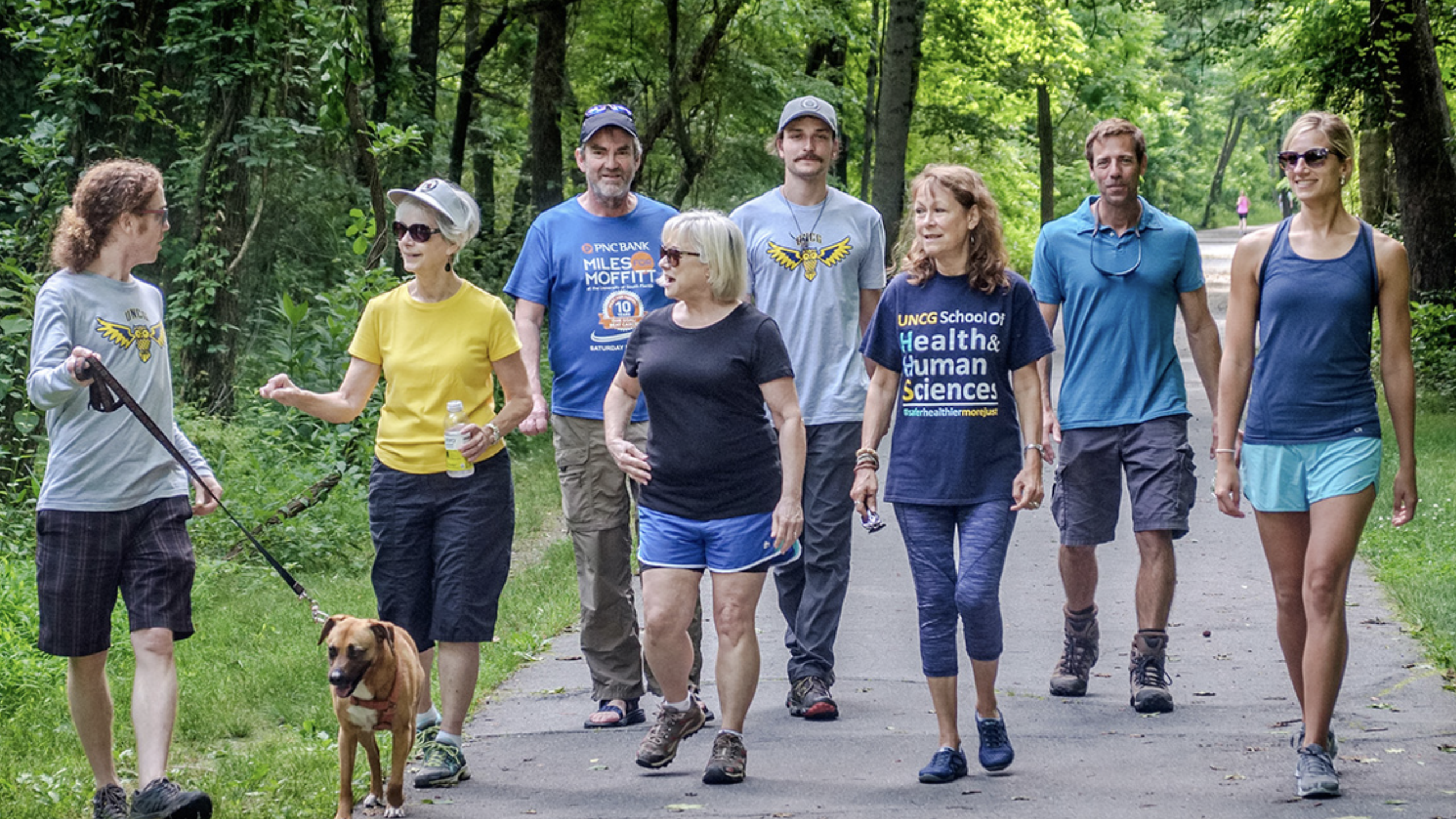 A group of CTR faculty walk along a park trail.